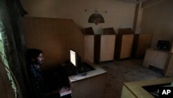 FILE - A man uses a computer at an internet cafe in Rawalpindi, Pakistan, Sept. 18, 2013