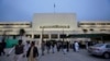 Members of the Pakistani media gather at the main entrance of National Assembly in Islamabad, Pakistan, Tuesday, March 21, 2017. Pakistan's National Assembly has passed a constitutional amendment for revival of military courts for trials of suspects invol