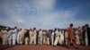 Internally displaced men from Bara line-up to be registered at the United Nations High Commission for Refugees supported Jalozai camp in Pakistan's northwest Khyber-Pakhtunkhwa Province October 23, 2011. Families continue to evacuate Bara on Sunday as the