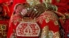 FILE - A bride holds her purse during a mass wedding ceremony in Karachi, Pakistan, May 9, 2016. 