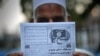 This photograph taken on September 3, 2014 shows a Pakistani man holding a pamphlet, allegedly distributed by the Islamic State (IS), in the northwestern Pakistani city of Peshawar.