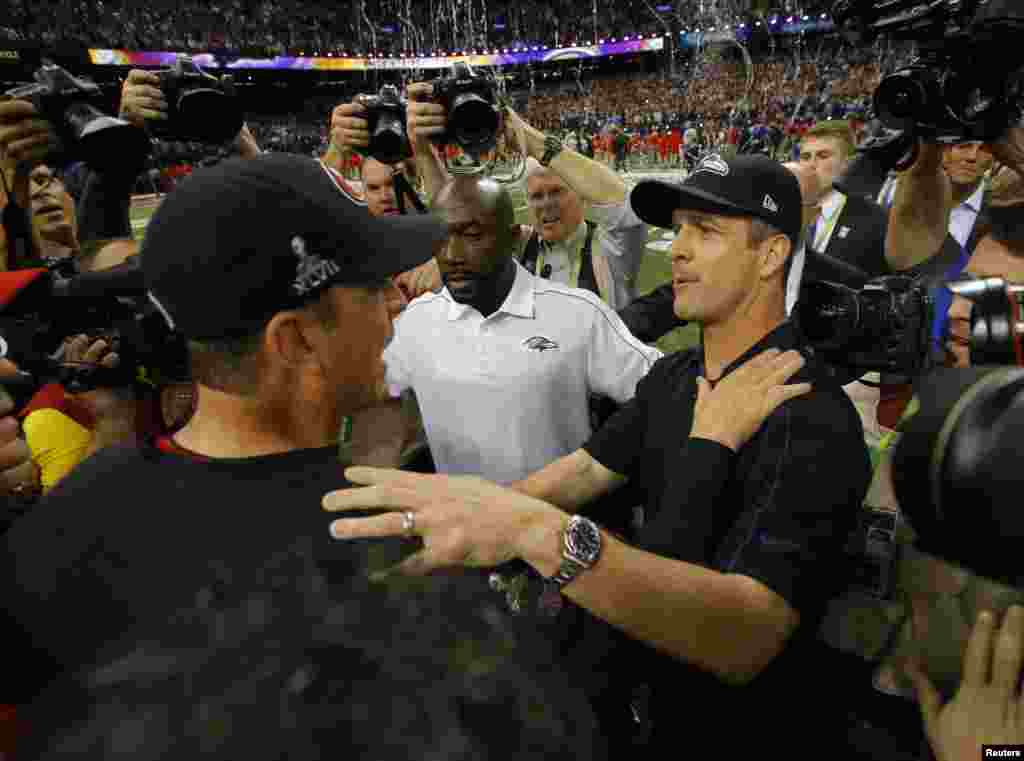 San Francisco 49ers head coach Jim Harbaugh (L) congratulates his brother, Baltimore Ravens head coach John Harbaugh, after the Ravens won in the NFL Super Bowl XLVII football game in New Orleans, Louisiana, February 3, 2013.