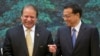 Pakistan's Prime Minister Nawaz Sharif (L) shares a light moment with Chinese Premier Li Keqiang before a signing ceremony held at the Great Hall of the People in Beijing July 5, 2013. REUTERS/Ng Han Guan/Pool (CHINA - Tags: POLITICS) - RTX11D76