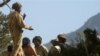 FILE - In this Thursday Oct. 2, 2003 file photo, a Pakistan army soldier guards captured al-Qaida activists and other militants at Angore Adda, in Pakistani tribal region near the Afghanistan border. Amnesty International has accused the Pakistani militar